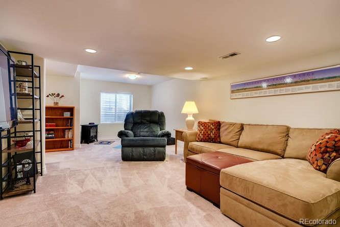 6123 Trailhead Road Highlands Ranch, CO 80130 - Photo 20 of 26 a living room with furniture and a couch