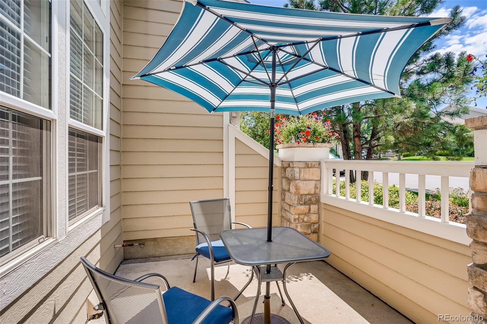 6123 Trailhead Road Highlands Ranch, CO 80130 - Photo 21 of 26 a view of balcony with furniture and umbrella