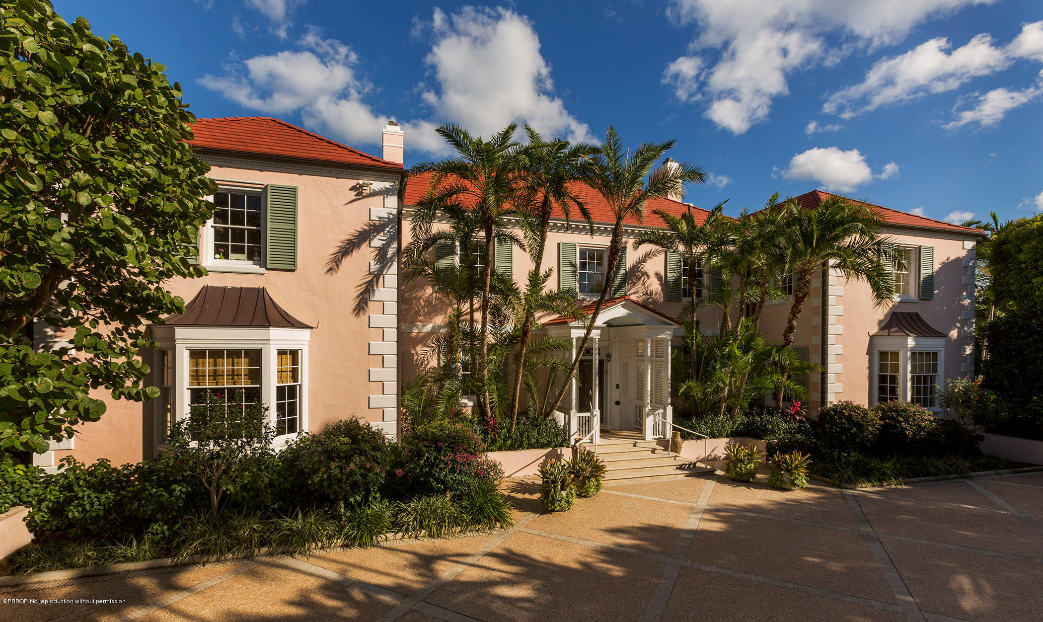 5 Middle Road Palm Beach, FL 33480 - Photo 1 of 7 a row of palm trees in front of a house