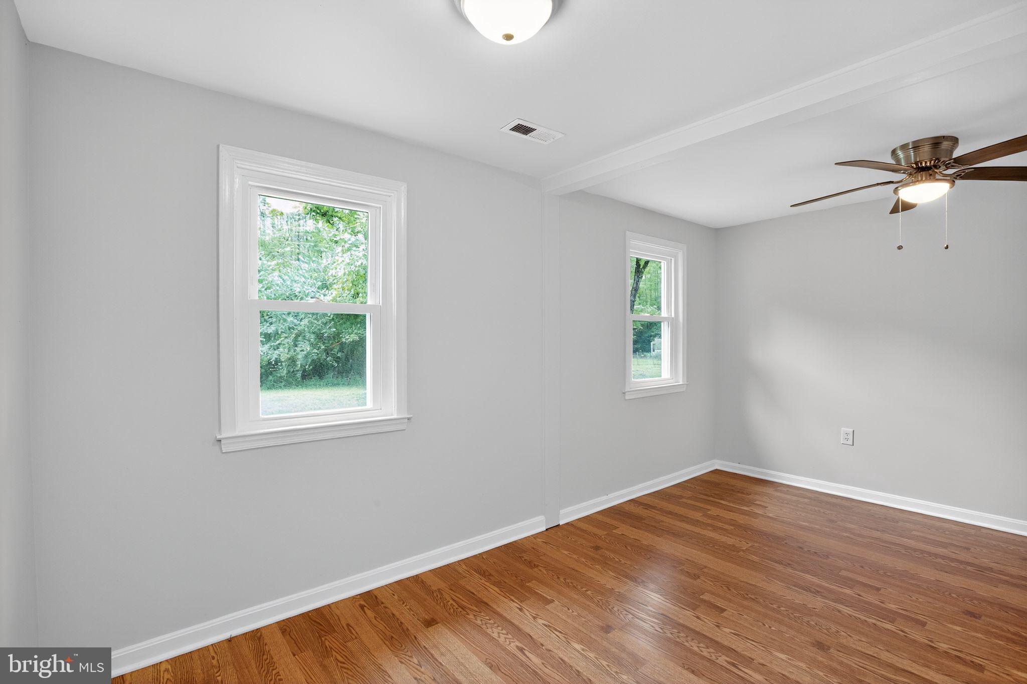 2895 Pomona Road Colonial Beach, VA 22443 - Photo 11 of 29 wooden floor in an empty room with a window