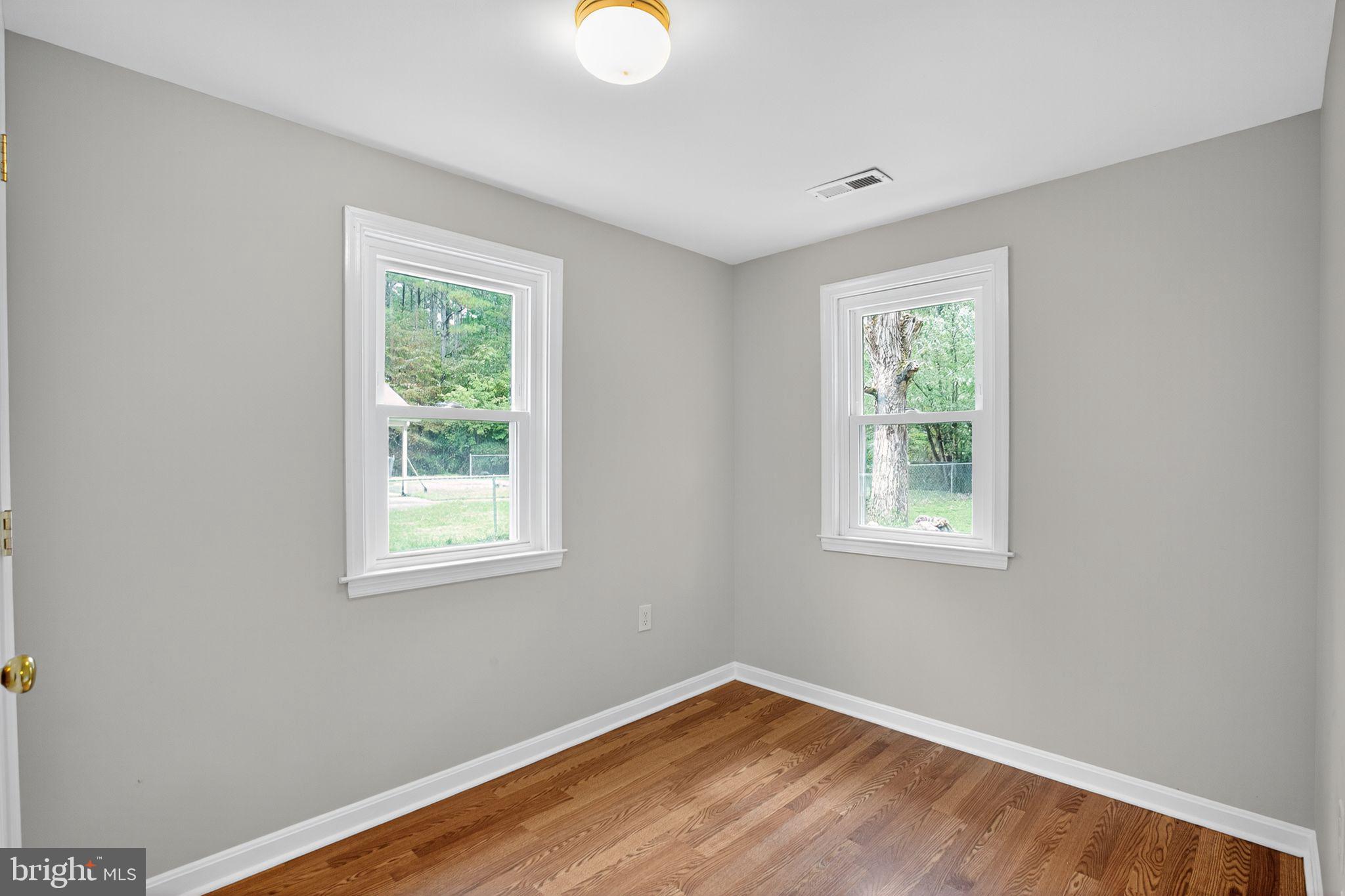 2895 Pomona Road Colonial Beach, VA 22443 - Photo 12 of 29 a view of an empty room with wooden floor and a window