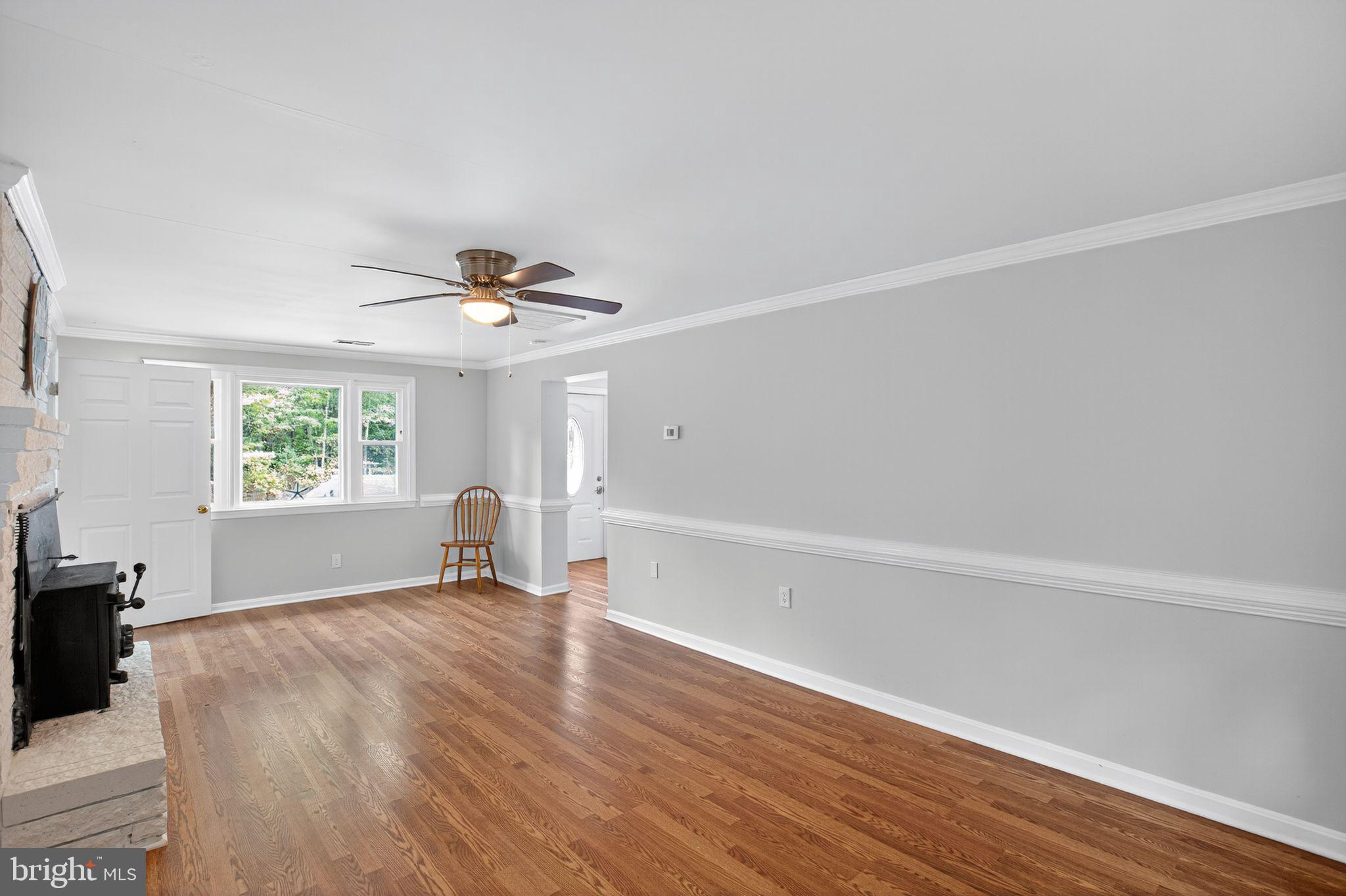 2895 Pomona Road Colonial Beach, VA 22443 - Photo 14 of 29 a view of empty room with wooden floor and fan