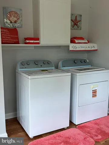 an empty room with wooden floor and ceiling fan