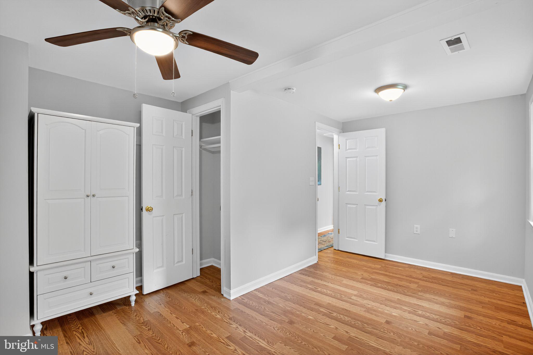 2895 Pomona Road Colonial Beach, VA 22443 - Photo 18 of 29 an empty room with wooden floor and ceiling fan