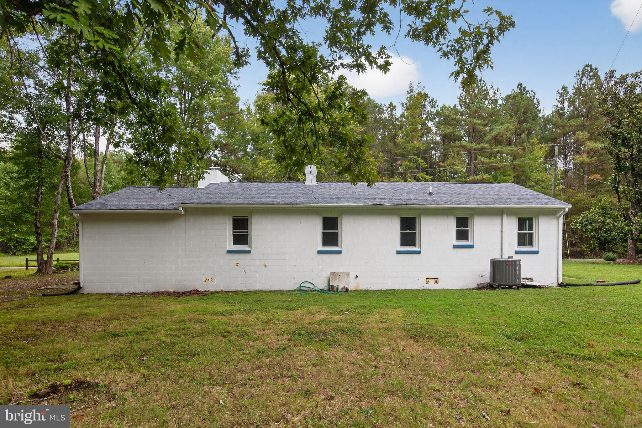 2895 Pomona Road Colonial Beach, VA 22443 - Photo 23 of 29 a house with green field in front of it