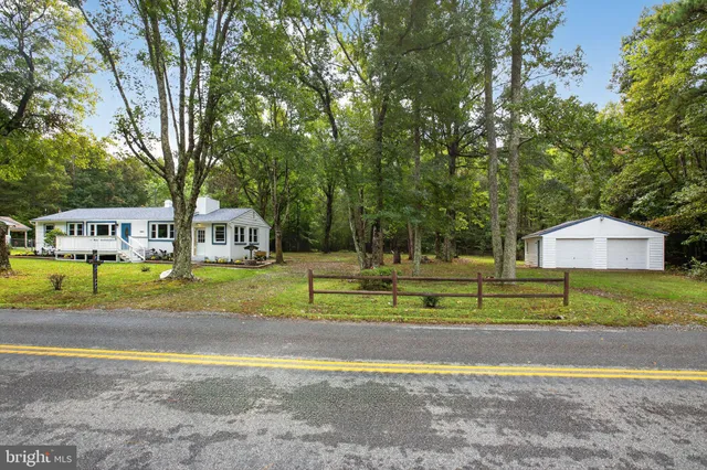 a view of yard with swimming pool and trees