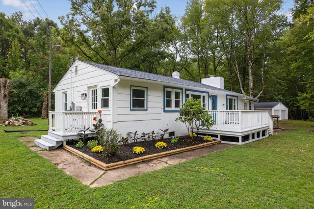 a front view of a house with a yard table and chairs