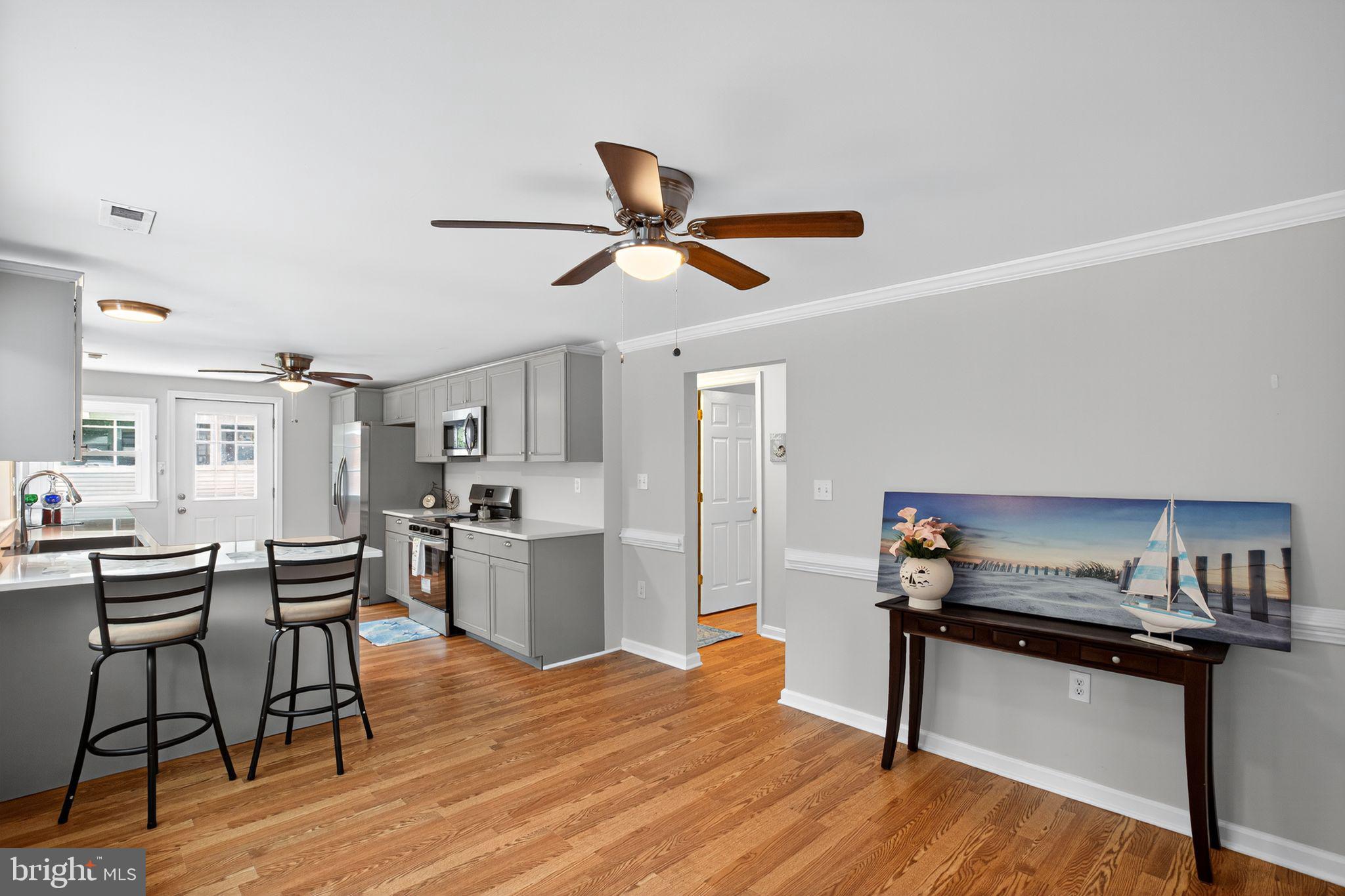 2895 Pomona Road Colonial Beach, VA 22443 - Photo 4 of 29 a living room with stainless steel appliances kitchen island hardwood floor and a kitchen view
