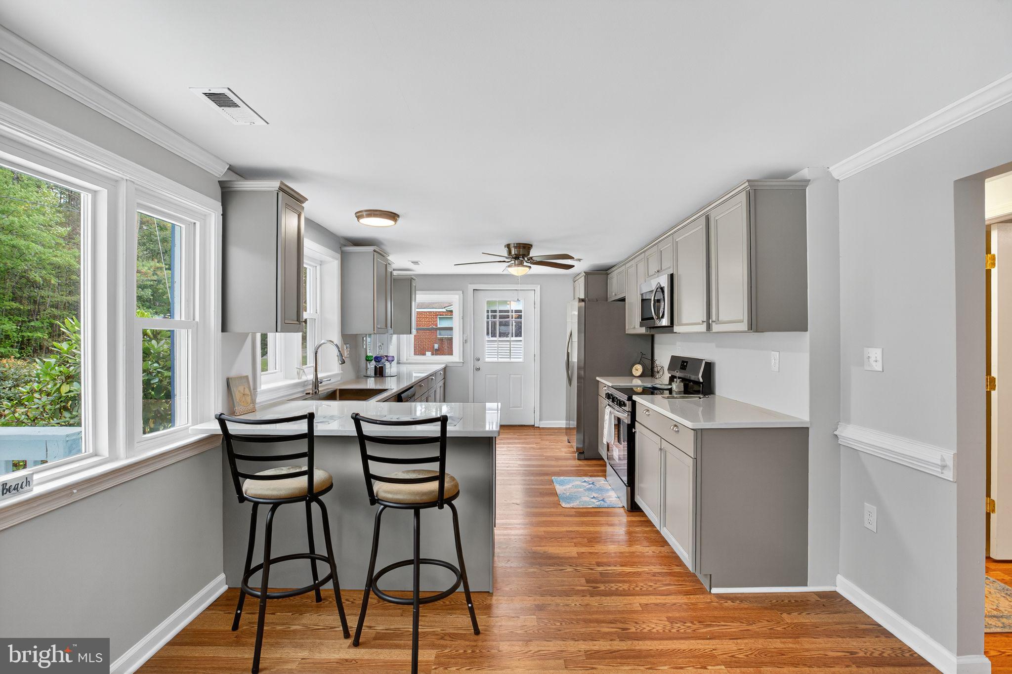 2895 Pomona Road Colonial Beach, VA 22443 - Photo 6 of 29 a view of a dining room with furniture window and wooden floor