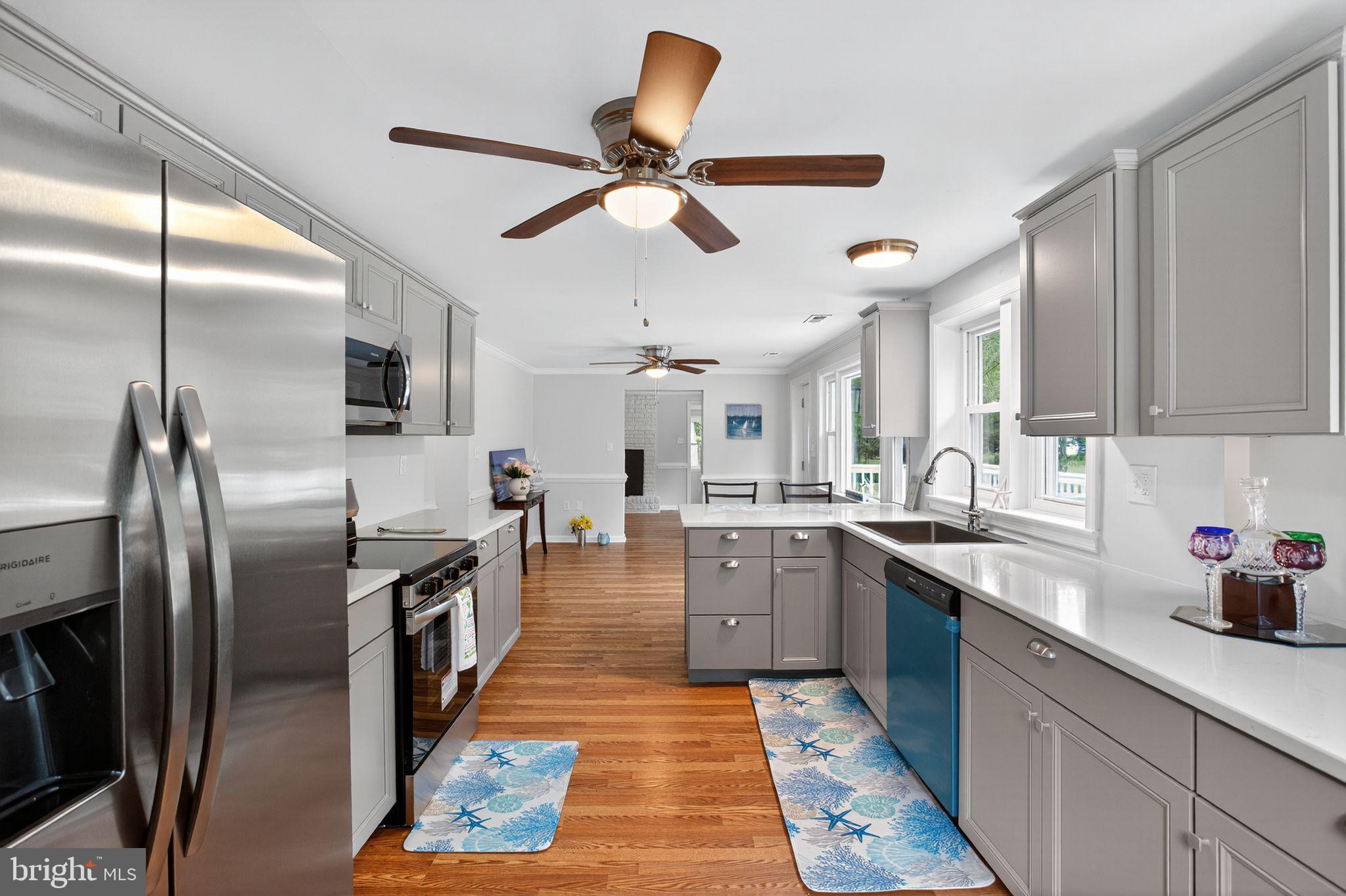 2895 Pomona Road Colonial Beach, VA 22443 - Photo 7 of 29 a kitchen with stainless steel appliances granite countertop a sink a stove and refrigerator