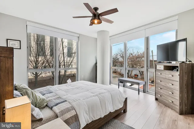 a bedroom with a bed and a flat tv screen