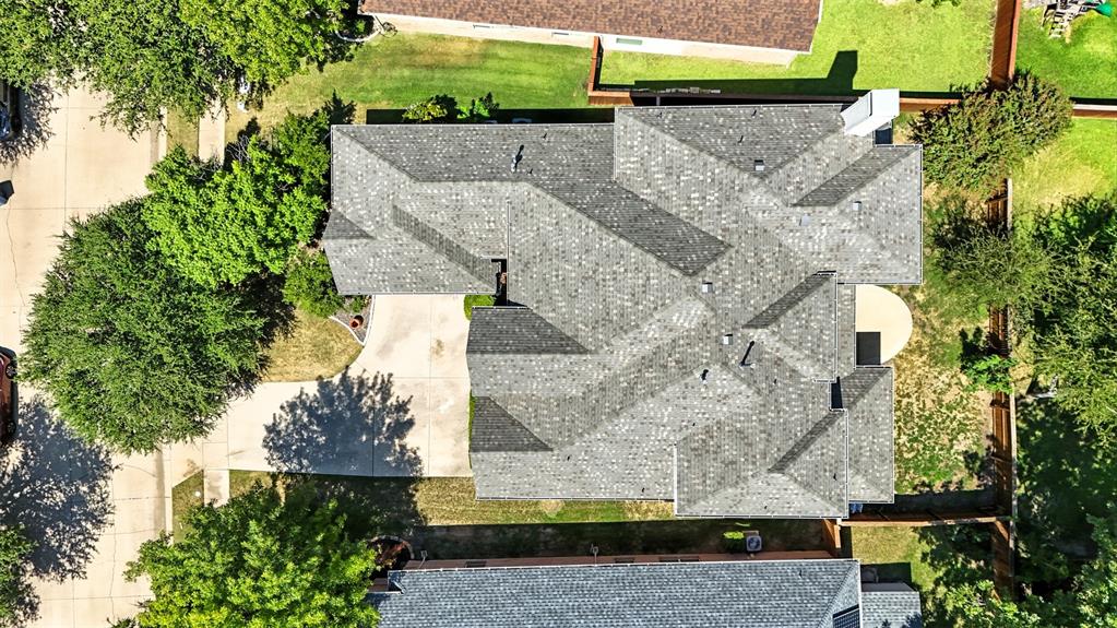 8220 Holliday Road Lantana, TX 76226 - Photo 4 of 40 Expansive gray shingle roofline featuring multiple gables and a visible chimney