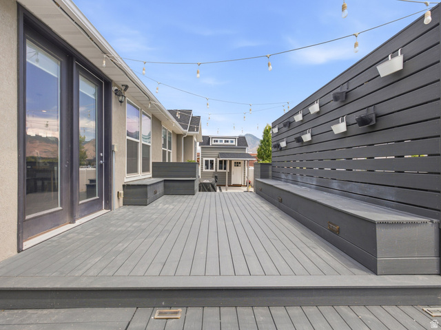 877 South Yarrow Drive Mapleton, UT 84664 - Photo 29 of 46 Spacious outdoor deck featuring composite decking, built-in bench seating, a privacy wall, and French patio doors