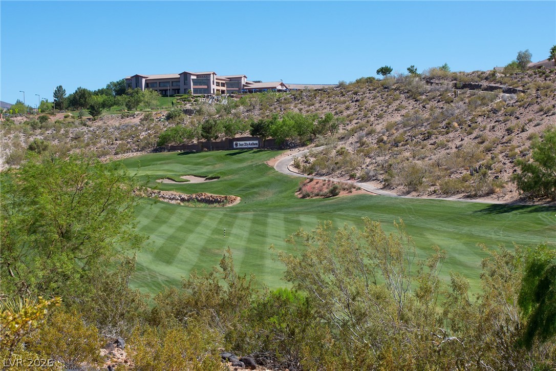 1680 Fieldbrook Street Henderson, NV 89052 - Photo 32 of 32 Lush fairways wind through the rugged desert landscape under clear blue skies.