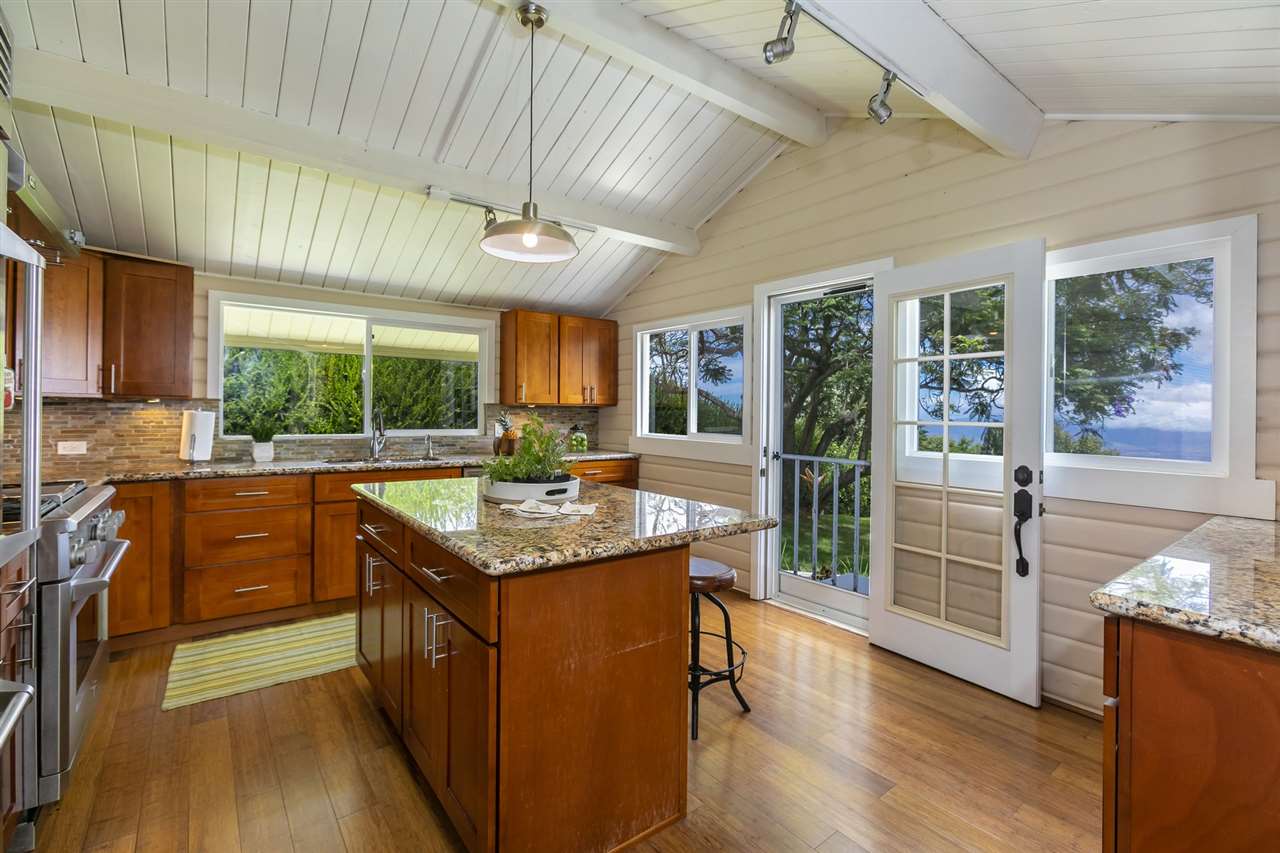 114 Alae Road Kula, HI 96790 - Photo 12 of 30 a kitchen with stainless steel appliances granite countertop a stove and a wooden floors