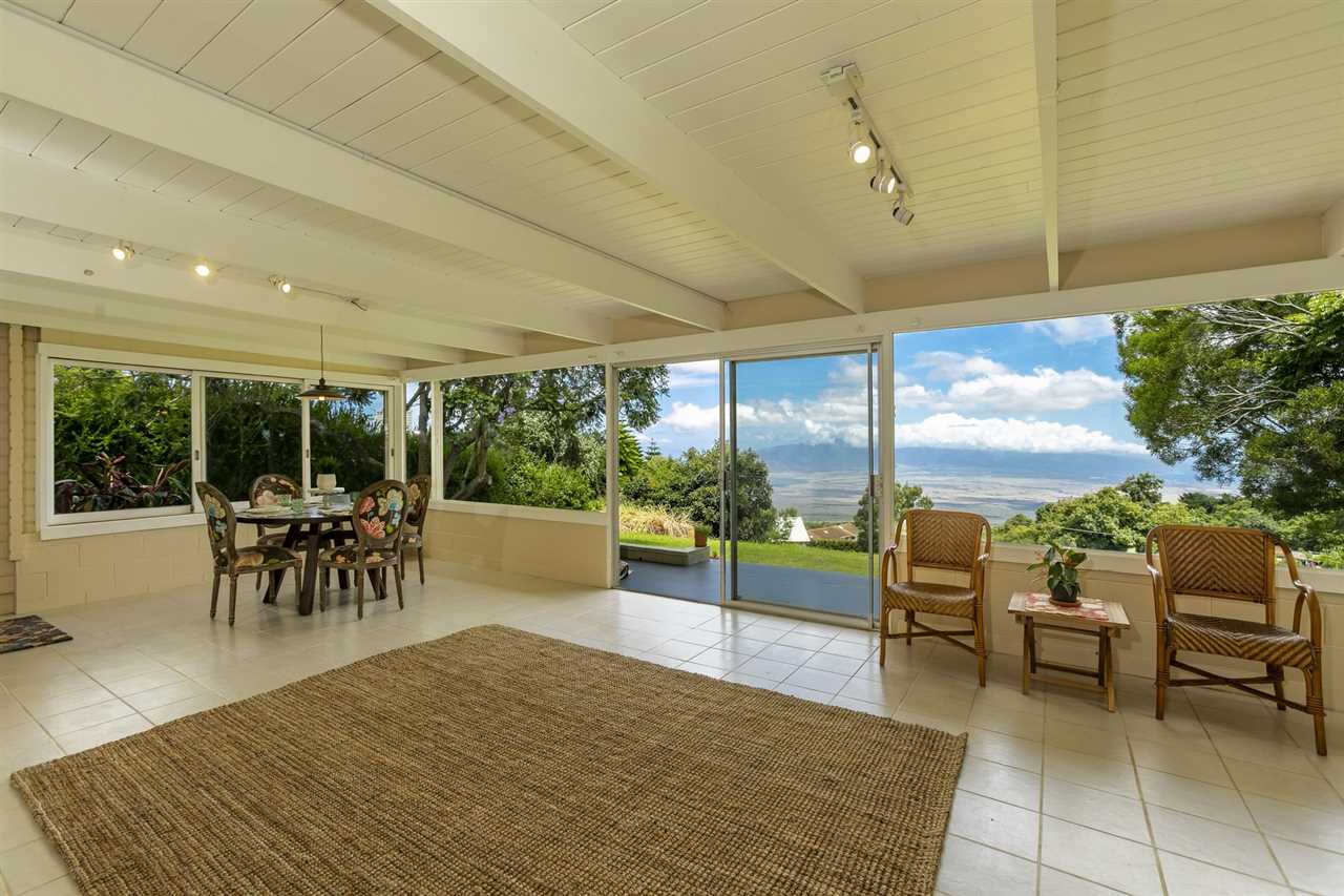 114 Alae Road Kula, HI 96790 - Photo 6 of 30 a view of a patio with a dining table and chairs