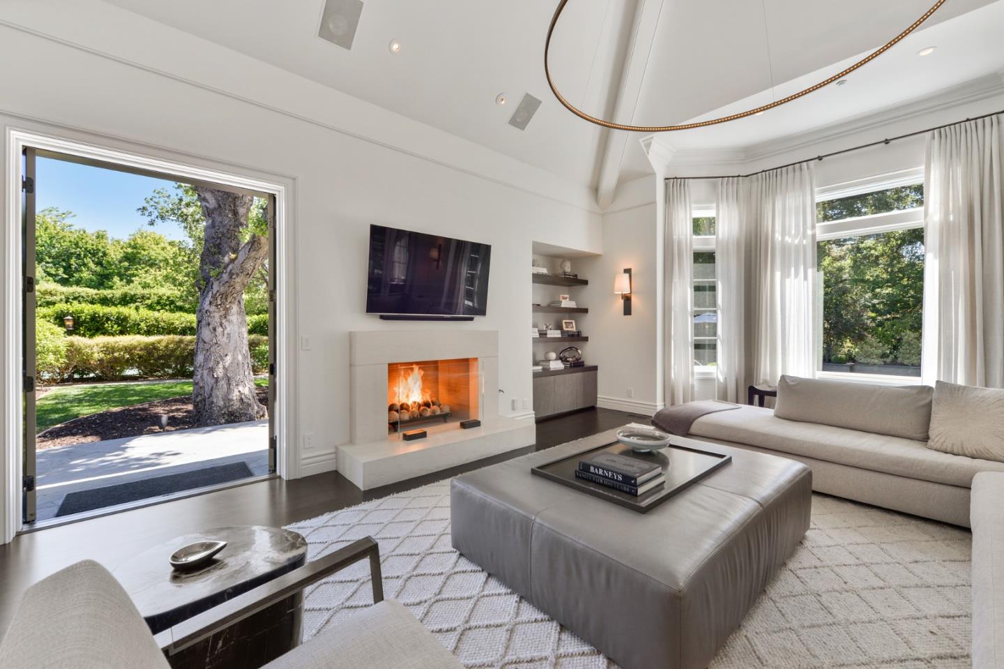 5 Faxon Forest Atherton, CA 94027 - Photo 16 of 46 a living room with furniture a flat screen tv and a fireplace
