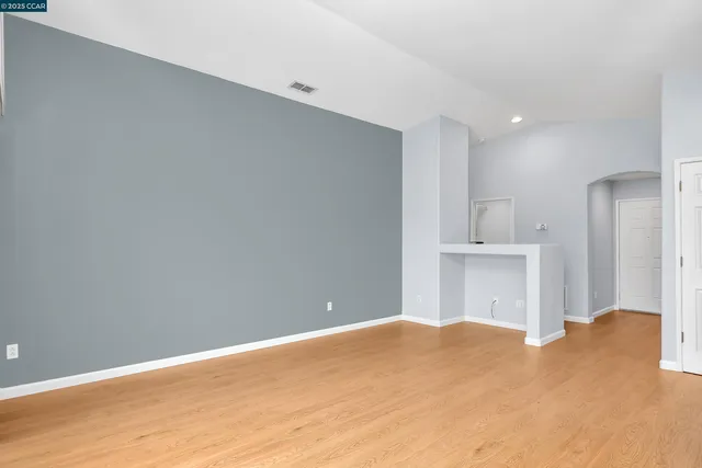a view of a bedroom with wooden floor and a bathroom