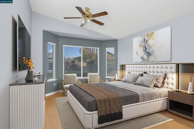 a bedroom with a large bed and a chandelier