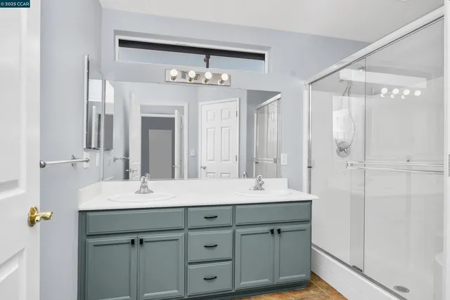 a bathroom with a double vanity sink and a mirror
