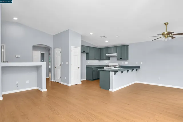 a kitchen with stainless steel appliances granite countertop a refrigerator and a sink