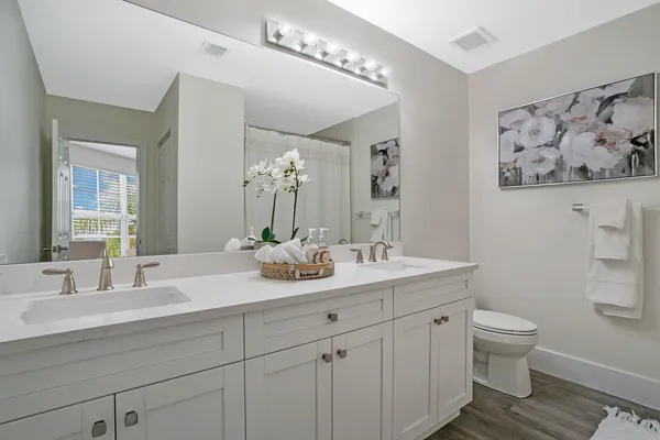 a bathroom with a double vanity sink and a mirror