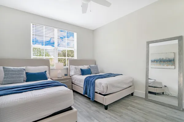 a bedroom with a bed and wooden floor