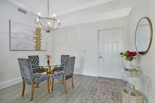 a view of a dining room with furniture and wooden floor