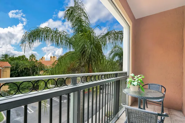 a view of a chair and table in the balcony