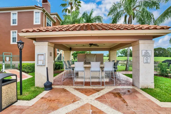 a view of a patio with a table and chairs and potted plants