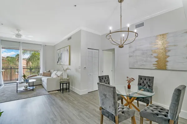 a view of a livingroom with furniture wooden floor and a chandelier
