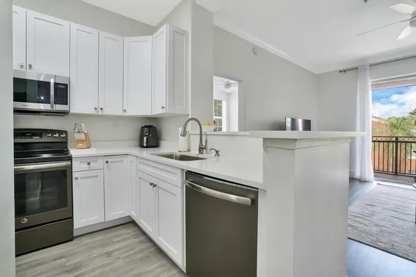 a kitchen with stainless steel appliances granite countertop a stove and a sink