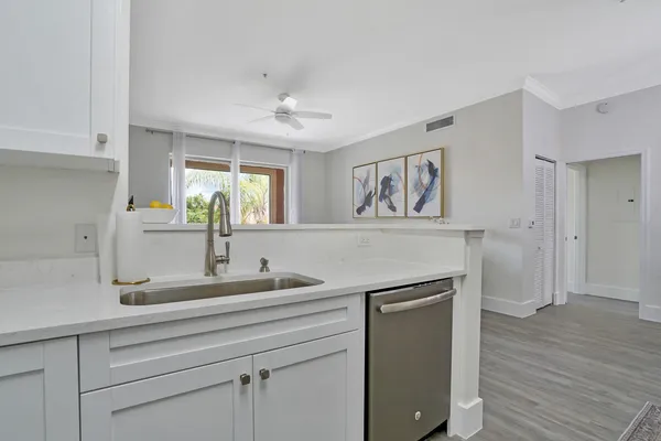 a kitchen with a sink and a refrigerator