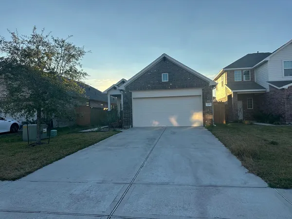 a front view of a house with a yard and a garage
