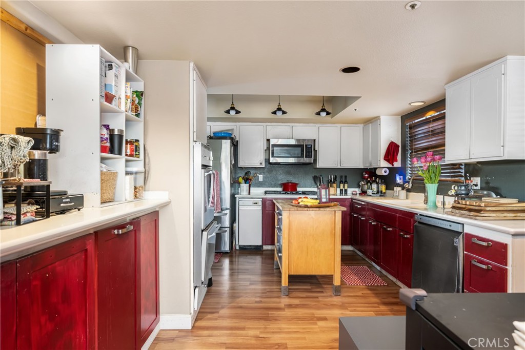 235 Via Ballena San Clemente, CA 92672 - Photo 21 of 51 a kitchen with stainless steel appliances granite countertop a refrigerator a stove top oven a sink and dishwasher with wooden floor