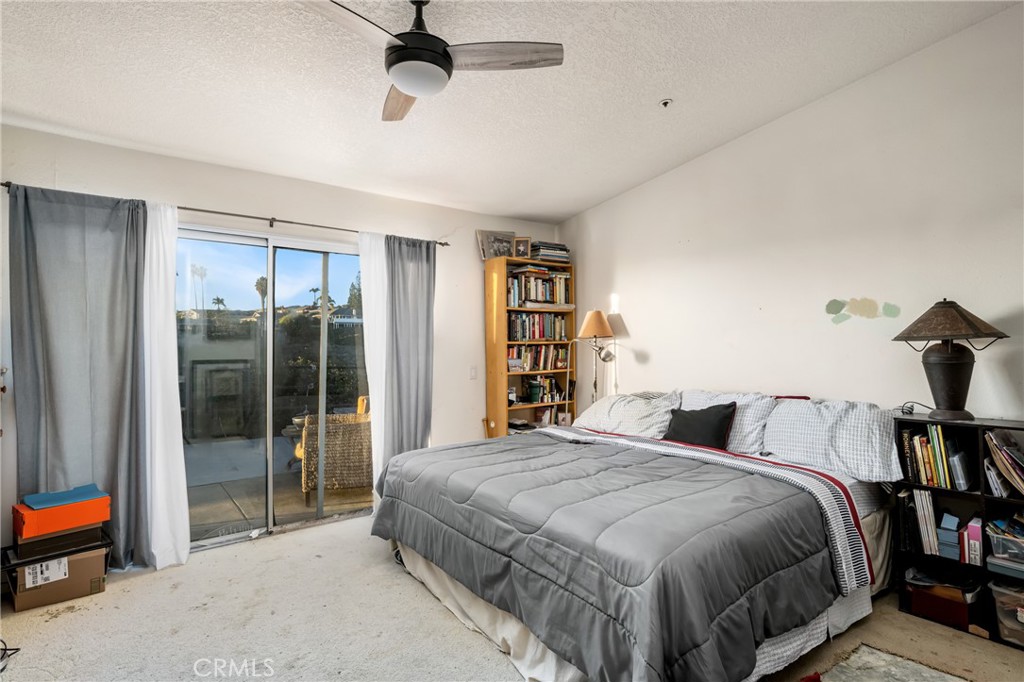 235 Via Ballena San Clemente, CA 92672 - Photo 24 of 51 a spacious bedroom with a bed and a book shelf