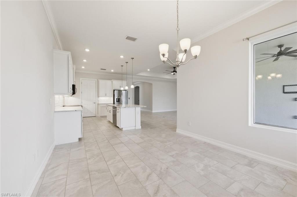 28053 Captiva Shell Loop Bonita Springs, FL 34135 - Photo 11 of 50 a view of kitchen with white cabinets and chandelier