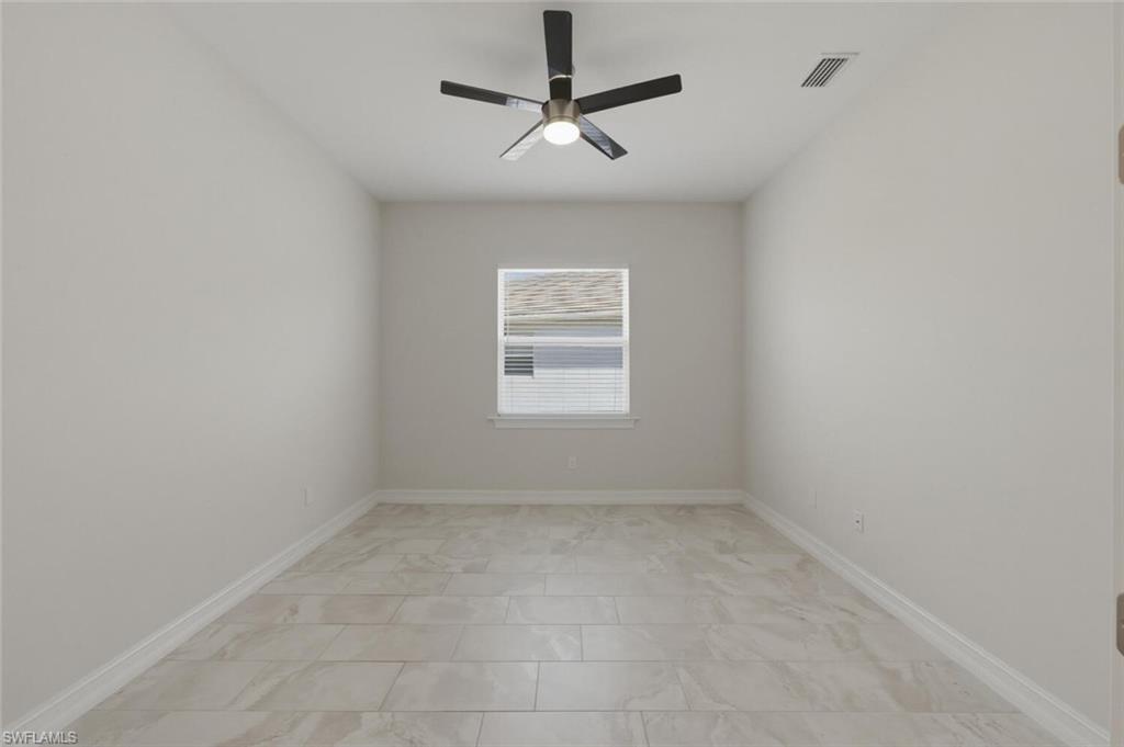 28053 Captiva Shell Loop Bonita Springs, FL 34135 - Photo 12 of 50 an empty room with a window and a ceiling fan