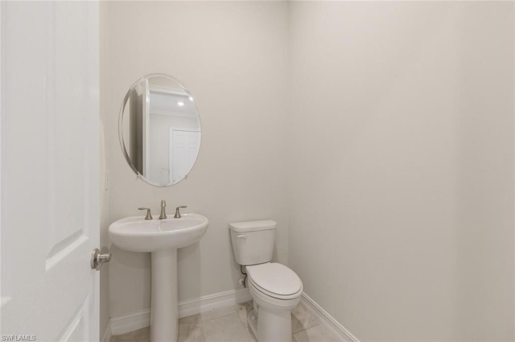 28053 Captiva Shell Loop Bonita Springs, FL 34135 - Photo 14 of 50 a bathroom with a sink mirror and toilet