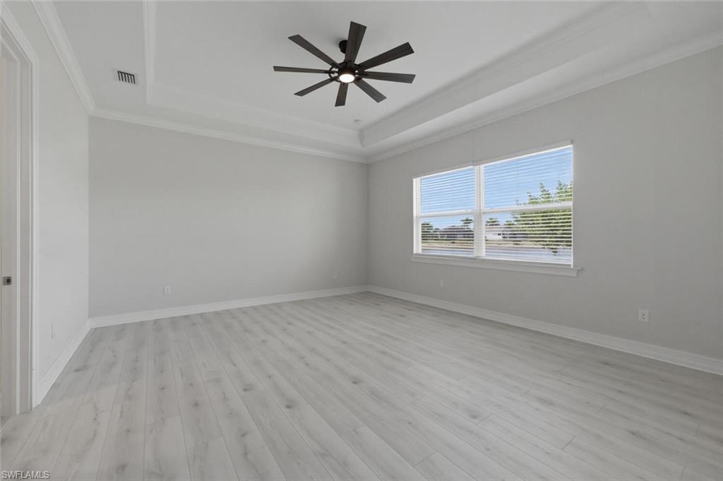 28053 Captiva Shell Loop Bonita Springs, FL 34135 - Photo 15 of 50 an empty room with wooden floor and ceiling fan