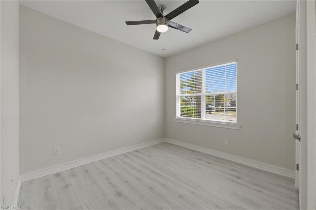 28053 Captiva Shell Loop Bonita Springs, FL 34135 - Photo 20 of 50 wooden floor in an empty room with a window