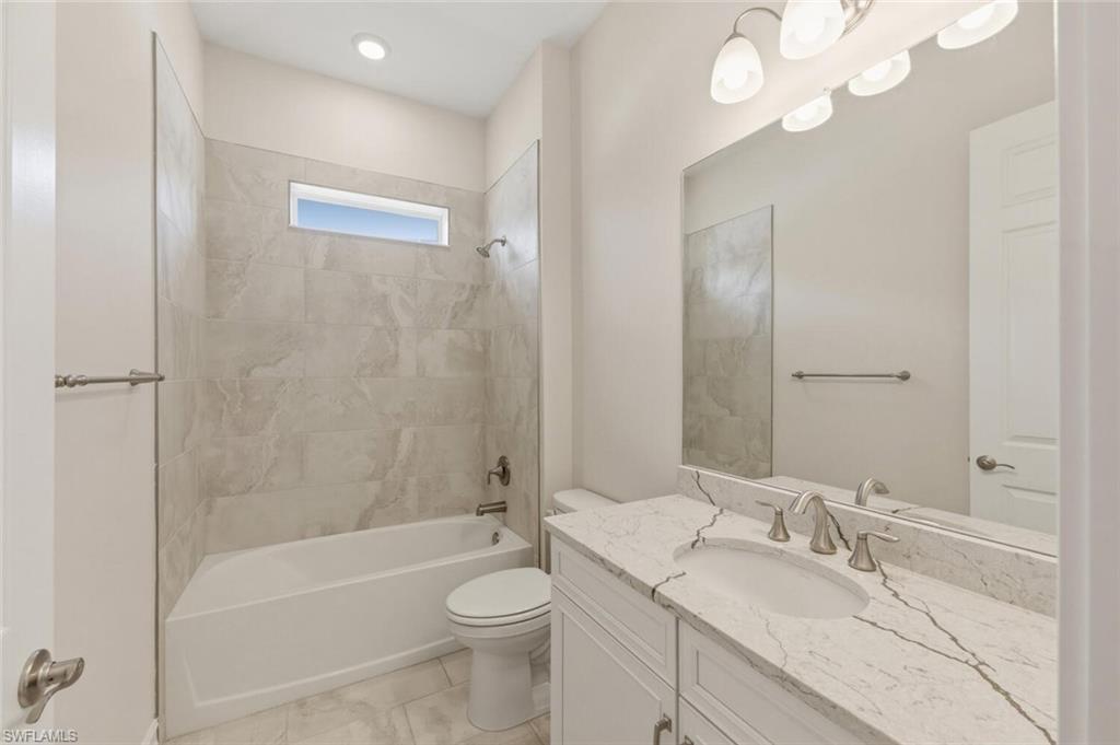 28053 Captiva Shell Loop Bonita Springs, FL 34135 - Photo 22 of 50 a bathroom with a granite countertop sink a toilet and bathtub
