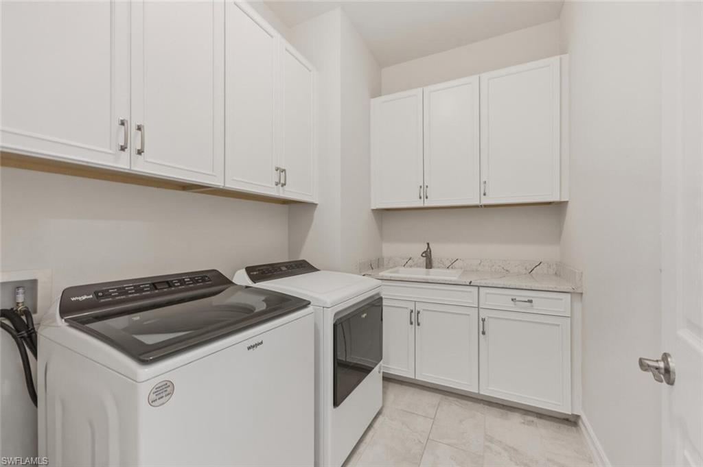 28053 Captiva Shell Loop Bonita Springs, FL 34135 - Photo 26 of 50 a view of a kitchen with sink and cabinets