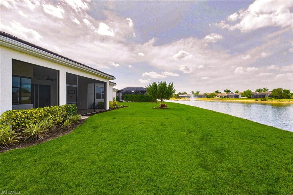 28053 Captiva Shell Loop Bonita Springs, FL 34135 - Photo 28 of 50 a view of a house with a big yard and a large tree