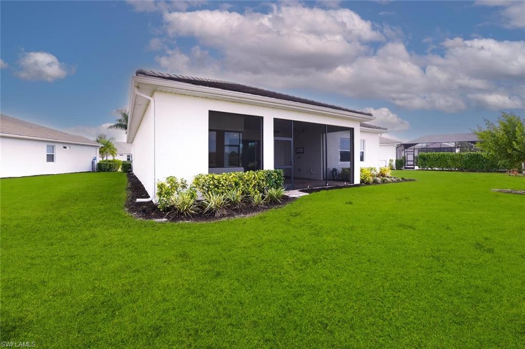 28053 Captiva Shell Loop Bonita Springs, FL 34135 - Photo 30 of 50 a view of a house with a backyard