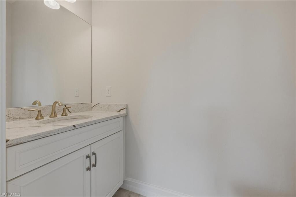28053 Captiva Shell Loop Bonita Springs, FL 34135 - Photo 36 of 50 a bathroom with a sink and a mirror