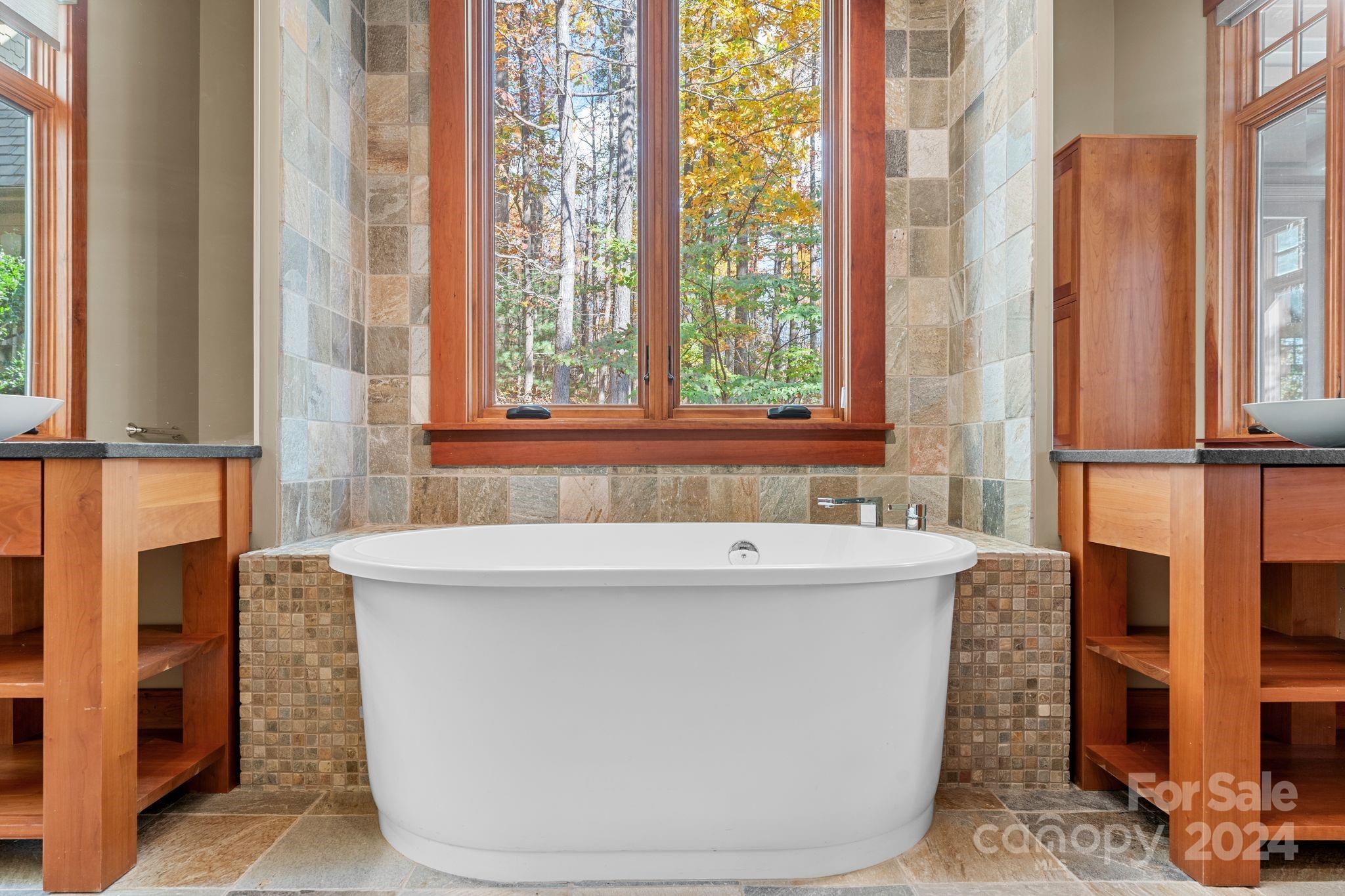 150 Cherry Hill Mill Spring, NC 28756 - Photo 16 of 39 a bath tub sitting next to a window