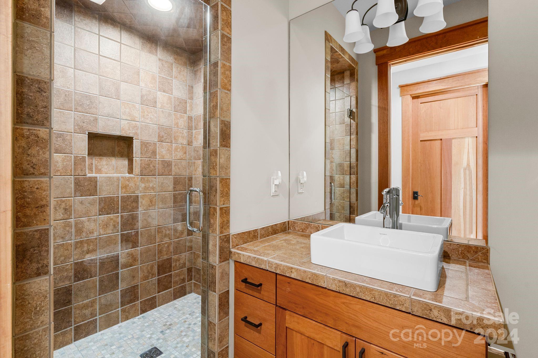 150 Cherry Hill Mill Spring, NC 28756 - Photo 19 of 39 a bathroom with a granite countertop sink a toilet and mirror