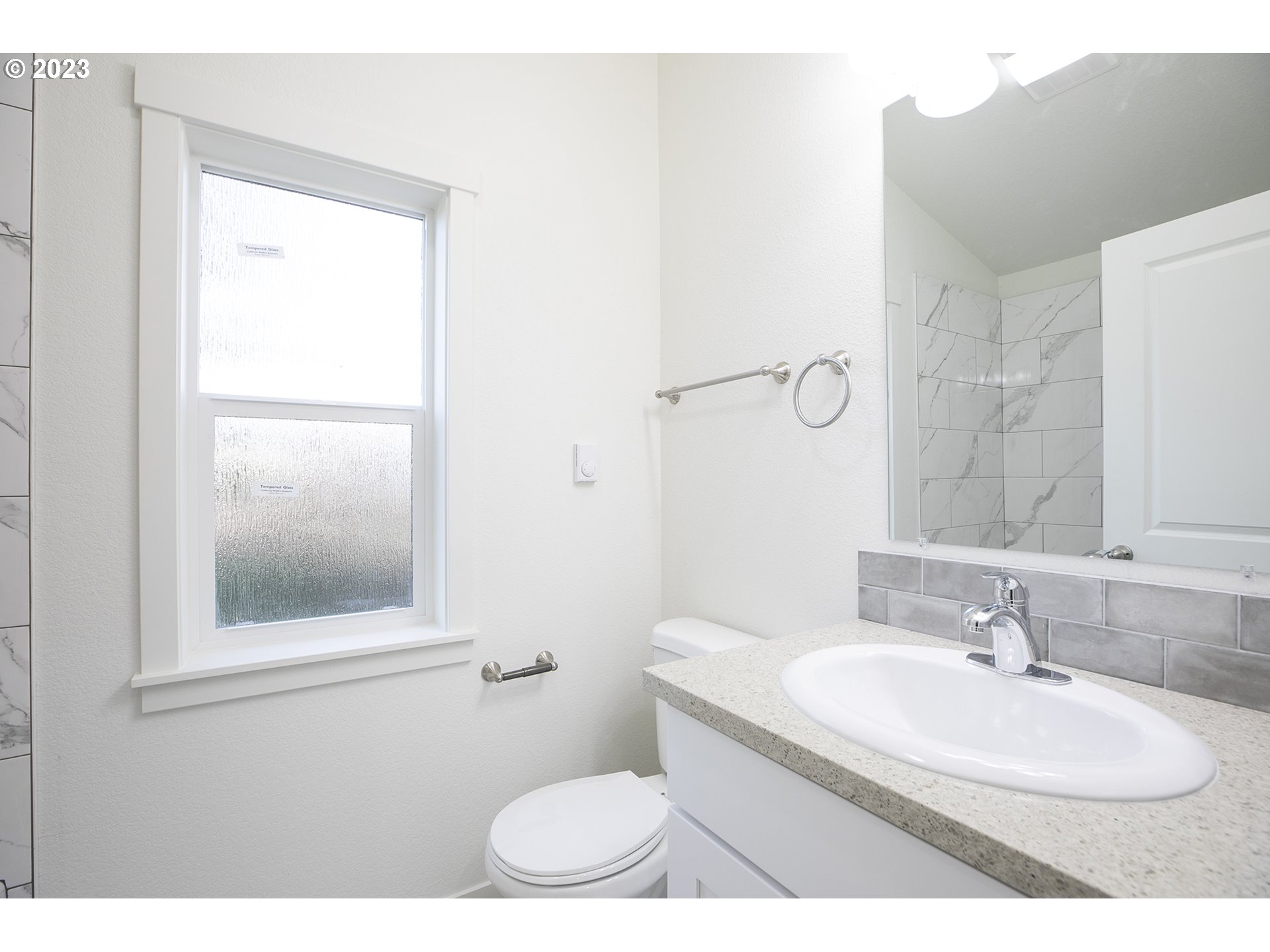 9046 Southeast Clinton Street, Unit B Portland, OR 97266 - Photo 13 of 18 a bathroom with a sink toilet and mirror