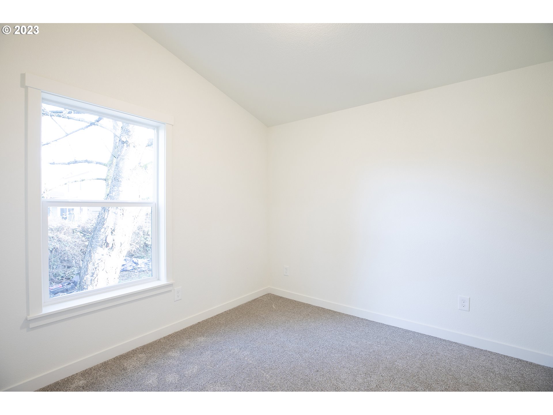 9046 Southeast Clinton Street, Unit B Portland, OR 97266 - Photo 15 of 18 a view of an empty room with a window